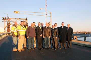 Freeholder Thomas A. Arnone and Freeholder Director Gary J. Rich, Sr. meet with officials from Manasquan and Brielle, Assemblyman David P. Rible and representatives from George Harms Construction at the Glimmer Glass Bridge, which was reopened 80 days ahead of schedule on Friday, March 13, 2015 in Manasquan, NJ. 