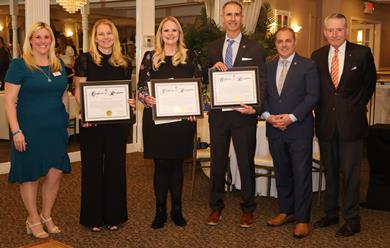 Deputy Director DiRocco posing with others and proclamations