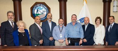 Group photo of Monmouth County Commissioners alongside County Employee Ken Perkins and two other employees of ITS
